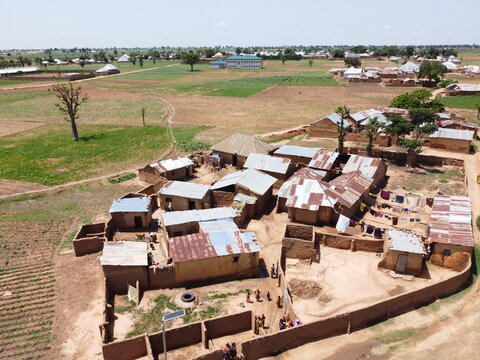 Zaria, Nigeria - 26 November 2025: Aerial view of sun-baked earth tones of the village contrast with the silver glint of corrugated iron roofs.