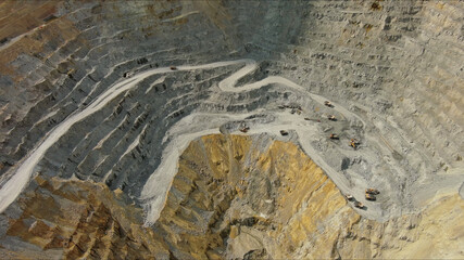 Aerial of open mine and heavy mining equipment