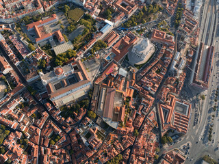 Aerial view of terracotta rooftops sprawling beneath the circular dome of the Church of Santa Engrácia and the Monastery of São Vicente de Fora, Lisbon, Lisbon, Portugal.