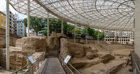 Ancient ruins under modern glass structure from the Roman Theater of Zaragoza, Spain