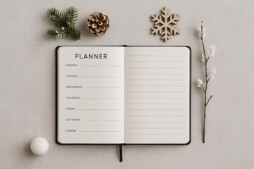 Open planner showing weekly layout and blank pages, surrounded by winter decorative elements, planning for upcoming holidays