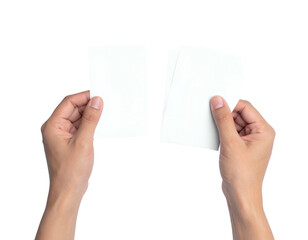 Hands holding blank white cards against black background
