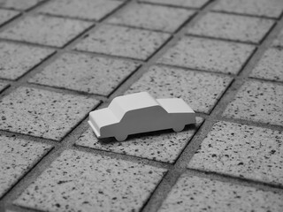 タイル地面に置かれたミニチュアカーの俯瞰イメージ