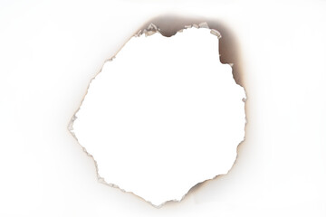A close-up view of a burnt hole with distinctly charred and smoky edges on a light background isolated on transparent background