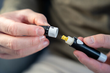 Individual setting up lancet for self-blood sugar testing
