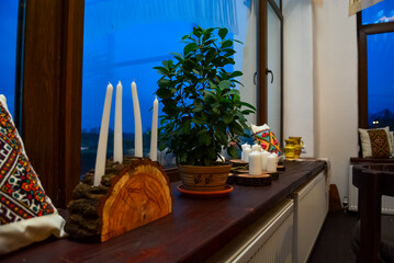 Cozy windowsill decor with candles and plant