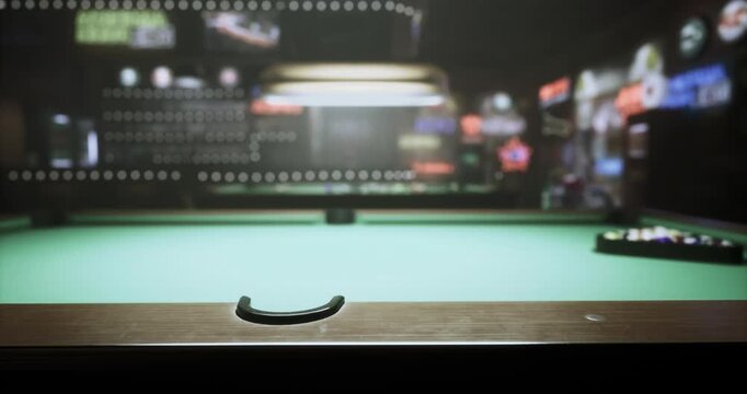 A green billiard table is set up in a dimly lit bar. The vibrant lights from neon signs and the relaxed ambiance create a perfect setting for playing pool and enjoying time with friends.