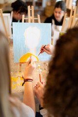 Mothers and children painting at art workshop