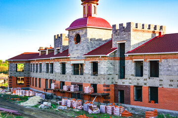 building under construction.  A construction site with a with a distinctive castle style architectural design. For architectural blogs, real estate promotions, materials about building techniques.