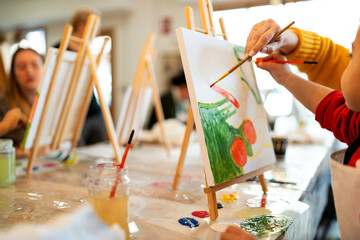 Mother and child painting together at art workshop