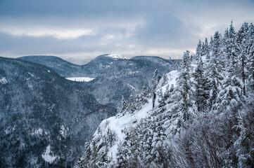 Horizon of high cliffs and mountains on a snowy day at Dome mountain, ZEC des martres, Charlevoix region, Quebec, Canada