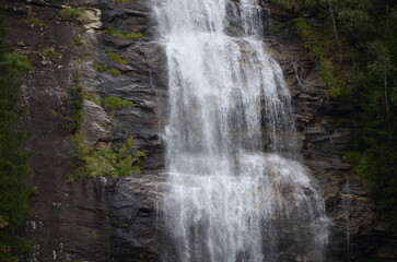 Obraz premium Waterfall in the Austrian Alps. Mountain and forest landscape.