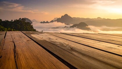 Wooden deck overlooks misty mountain range at sunrise