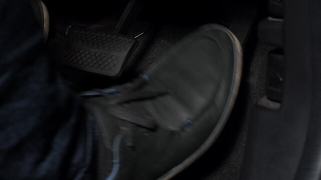 Accelerate and Brake. Foot pressing foot pedal of a car to drive ahead. Man driving car by pressing Accelerator and Brake in car. Driver driving the car by pushing accelerator pedals of the car inside