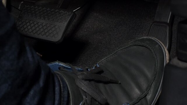 Accelerate and Brake. Foot pressing foot pedal of a car to drive ahead. Man driving car by pressing Accelerator and Brake in car. Driver driving the car by pushing accelerator pedals of the car inside
