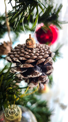 Close-up of Festive Pinecone and Glitter Star Ornaments on a Christmas Tree