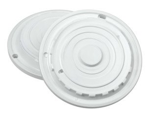 Two white circular plastic components with raised concentric rings