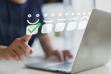 Man hand pointing at a virtual screen with happy face icon and green check mark for customer service evaluation. Great for user experience, satisfaction rating, and business feedback concept.