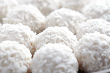 White truffles with coconut flakes close up. Crispy sweet balls. 