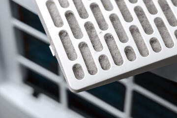 Dust filled filter cartridge of a room dehumidifier close up. Used filtration component