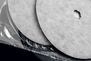 New clean industrial water filters with grey fiber texture over their clear plastic packaging