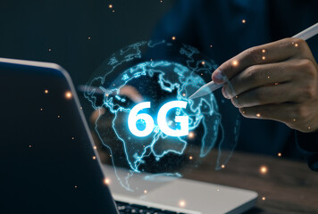 A professional interacts with a holographic 6G globe, representing next-generation wireless technology, ultra-fast connectivity, future networks, global data exchange, and innovation.