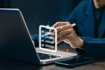 A professional checks a digital checklist on a laptop, representing task management, workflow organization, project tracking, productivity improvement, and business process control.