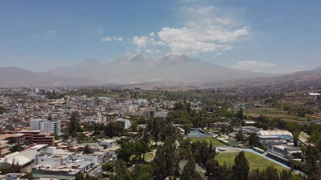 Aerial drone flying forward toward Chachani Volcano over Arequipa city, Peru