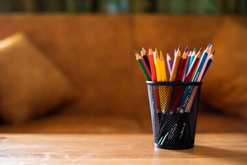 Colored pencils in holder with copy space for creativity and education.