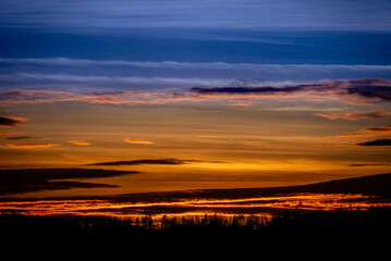 Dramatic sunset background with cloudy sky.