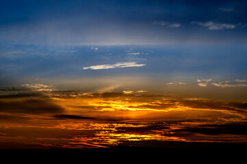 Dramatic sunset background with cloudy sky.