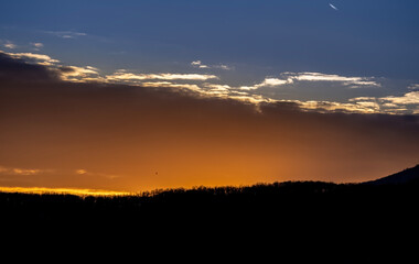 Dramatic sunset background with cloudy sky.
