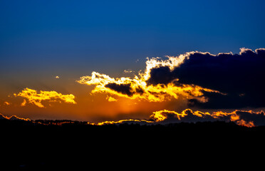 Dramatic sunset background with cloudy sky.