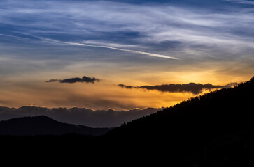 Dramatic sunset background with cloudy sky.