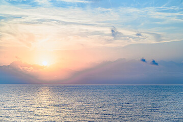 Beautiful orange sunrise sky over the sea horizon. Summer golden hour.