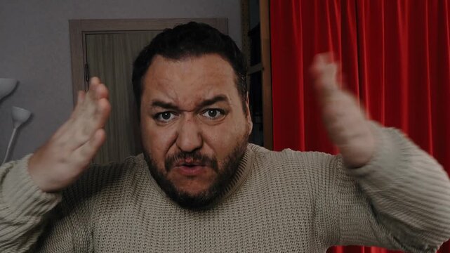 An angry man swears and shouts