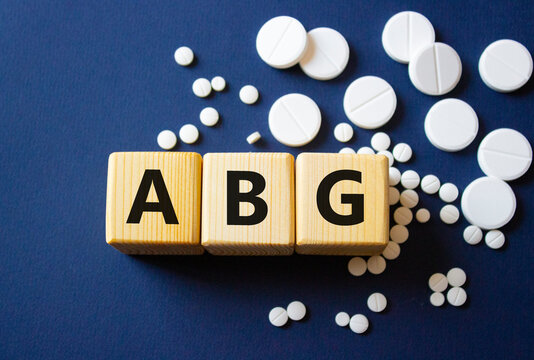 ABG symbol. Wooden cubes with words ABG Arterial Blood Gas. Beautiful deep blue background. Healthcare and Arterial Blood Gas concept. Copy space.