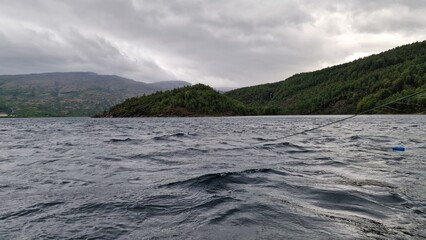 Langvatnet is a large freshwater lake in Norway, located in a remote mountainous landscape that also forms part of a former and active mining area. The surroundings combine natural beauty with industr