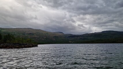 Langvatnet is a large freshwater lake in Norway, located in a remote mountainous landscape that also forms part of a former and active mining area. The surroundings combine natural beauty with industr