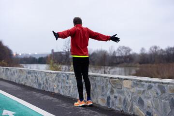 a man is exercising and running on a track next to a river