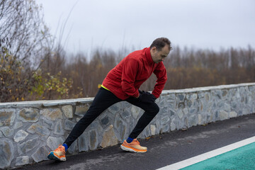 a man is exercising and running on a track next to a river