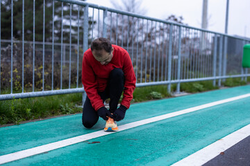a man is exercising and running on a track next to a river