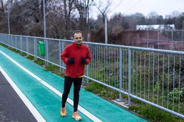 a man is exercising and running on a track next to a river