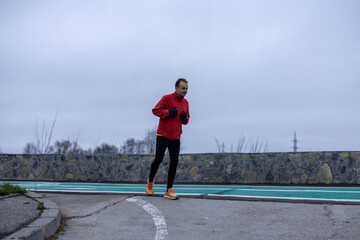 a man is exercising and running on a track next to a river