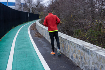 a man is exercising and running on a track next to a river