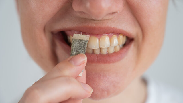 A woman uses chewing tobacco. 