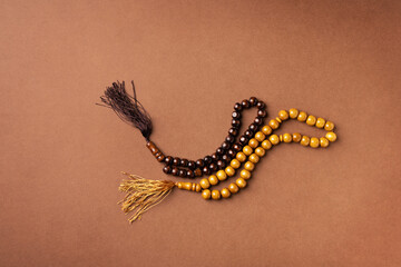 Ramadan Kareem concept, rosary on brown background