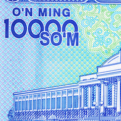 A 2017 banknote of 10000 Uzbek soums. The obverse depicts the state emblem. The reverse side of the banknote features an image of the Senate building in Tashkent.