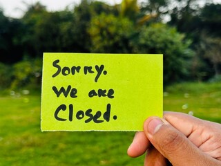 We are Closed hand note, We're Closed now sticky note hanging