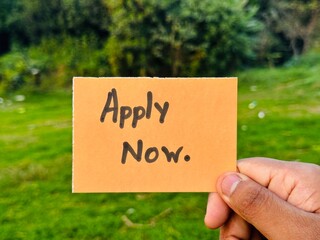 Apply now handwritten note, Apply now colorful sign on hand